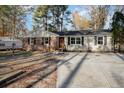 Charming single-story home with brick and vinyl siding, black shutters, and a lovely front door at 5917 Meadowlark Ln, Raleigh, NC 27610