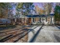 Charming single-story home with brick and vinyl siding, black shutters, and a lovely front door at 5917 Meadowlark Ln, Raleigh, NC 27610