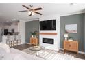 Cozy living room with modern fireplace, mounted TV, ceiling fan, and stylish decor at 5918 Giddings St, Raleigh, NC 27616