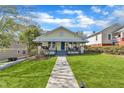 Charming home featuring a covered front porch, well-manicured lawn, and inviting curb appeal at 602 Dunbar St, Durham, NC 27701