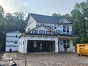 New construction home features two stories and an attached two-car garage awaiting finishing at 61 Fetterbush Way, Clayton, NC 27520