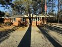 Attractive one-story brick home with a ramp and American flag, perfect for accessible living at 640 Crocker Rd, Smithfield, NC 27577