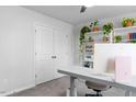 Bright bedroom featuring a closet, neutral carpet, and a modern built-in shelving unit with plants at 6412 Nurture Ave, Raleigh, NC 27616