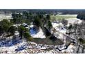 An aerial view of the land parcel highlighting the pond, trees, and surrounding areas in the winter at 6509A Fowler Rd, Zebulon, NC 27597