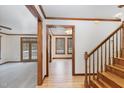 View of the foyer with a staircase and doorway leading to the living room with a fireplace at 7212 Rabbit Run, Wake Forest, NC 27587