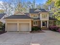 Charming home with a three-car garage, a brick and stucco facade, and lush landscaping in a desirable neighborhood at 73214 Burrington, Chapel Hill, NC 27517