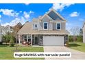 Beautiful two-story home featuring a stone veneer, covered porch, and a two-car garage at 825 Golden Plum Ln, Zebulon, NC 27597