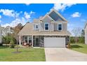 Beautiful two-story home with stone accents, a well-kept lawn, and inviting front porch at 825 Golden Plum Ln, Zebulon, NC 27597