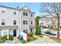 Charming exterior of a townhome featuring well-kept landscaping and a cozy neighborhood setting at 8641 Neuse Club Ln # 110, Raleigh, NC 27604