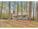 Quaint blue home nestled among tall trees, offering a serene and private setting at 1010 Flanders St, Garner, NC 27529