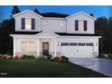Charming two-story home featuring a white exterior, black shutters, and a well-manicured lawn at 1130 Winding Spring Dr, Mebane, NC 27302