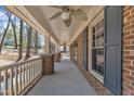 Spacious covered porch featuring brick columns, ceiling fans, and natural light at 1133 Turner Farms Rd, Garner, NC 27529