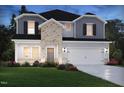 Charming two-story home with brick and siding, complemented by a well-manicured lawn and attractive landscaping at 1135 Winding Spring Dr, Mebane, NC 27302