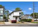 Modern two-story home boasts clean lines, a well-maintained front yard, and inviting curb appeal at 1208 Garner Rd, Raleigh, NC 27610