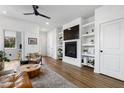 Inviting living room features built-in shelves, fireplace, and modern ceiling fan at 1208 Garner Rd, Raleigh, NC 27610