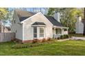 Side view of the home with a bay window and manicured landscaping at 1210 Ventura Springs Ct, Wake Forest, NC 27587