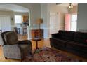 Inviting living room with hardwood floors, neutral walls, and an open view to the kitchen at 126 W Quail Ridge Rd, Oxford, NC 27565