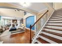Elegant entryway with hardwood floors, grand staircase, and view into the open-concept living space at 1524 Catch Fly Ln, Durham, NC 27713