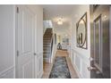 Inviting entryway features hardwood floors, wainscoting, and stylish decor at 160 Bruce Dr, Dunn, NC 28334