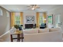 Bright living room with large windows, neutral decor, and stylish furnishings at 160 Bruce Dr, Dunn, NC 28334