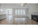 Inviting living room with a cozy fireplace and natural light, seamlessly flowing into adjacent spaces at 185 W Amber Oak Dr, Selma, NC 27576
