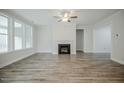 Expansive living room offers a fireplace, large windows, and a versatile layout for relaxation and entertainment at 185 W Amber Oak Dr, Selma, NC 27576