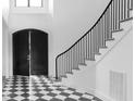 Bright foyer featuring a curved staircase and a striking black and white checkerboard floor at 186 Evington Dr, Pittsboro, NC 27312