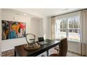 Brightly lit office boasts a modern desk, comfortable chair, and large window views at 201 Olive Branch St, Sanford, NC 27332