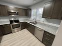 Modern kitchen features stainless steel appliances, granite countertops, and dark wood cabinetry at 204 Allen St # A/B, Creedmoor, NC 27522