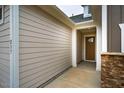 Exterior shot of home showing a covered walkway to the front door, stone accents and horizontal siding at 237 Abercorn Cir, Chapel Hill, NC 27516