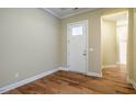 Inviting foyer features hardwood floors, a white door with glass, and neutral paint at 237 Abercorn Cir, Chapel Hill, NC 27516