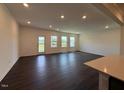 Bright living room features wood flooring, a back patio door and multiple windows at 237 Shingle Oak Rd, Wake Forest, NC 27587