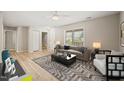 A bright living room showcases a large window, wood flooring, and plush seating perfect for relaxation at 2416 Boothbay Ct, Raleigh, NC 27613