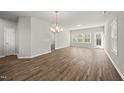 Bright, spacious living room with wood-look floors, neutral paint, and abundant natural light at 248 Shingle Oak Rd, Wake Forest, NC 27587