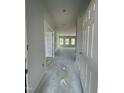 Bright hallway leading to the living area, showcasing the home's spacious layout and natural light at 249 Spilona Way # 64, Four Oaks, NC 27524
