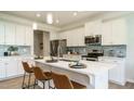 Modern kitchen with stainless steel appliances, a large island with seating, and ample cabinet space at 249 Spilona Way # 64, Four Oaks, NC 27524