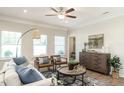 Tastefully decorated living room with stylish furniture, a ceiling fan, and a view of the outdoors at 249 Spilona Way # 64, Four Oaks, NC 27524