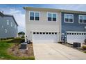 Two-car garage door and driveway and manicured yard on a sunny day at 249 Wendover Pkwy, Pittsboro, NC 27312