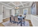Dining room boasts coffered ceilings, neutral walls, and wood floors with seating for six at 274 Ashpole Trl, Clayton, NC 27520