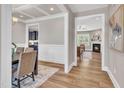 View of dining room with coffered ceilings and view into the living room with fireplace at 274 Ashpole Trl, Clayton, NC 27520