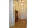 Bright foyer with hardwood floors, classic decor, and a view of the front door at 2801 Glenwood Gardens Ln # 106, Raleigh, NC 27608