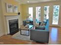 Stylish living room with a fireplace, comfortable seating, and access to a balcony at 2801 Glenwood Gardens Ln # 106, Raleigh, NC 27608