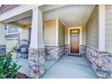 Inviting front porch with stone accents and a comfortable seating area for enjoying the outdoors at 296 Providence Creek Dr, Fuquay Varina, NC 27526