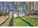 Exterior view of a charming home with a well-maintained yard and classic architecture surrounded by beautiful trees at 3022 Dixon Rd, Durham, NC 27707