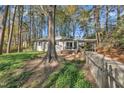 This is a charming home featuring a covered carport, small deck and lovely yard, nestled in a wooded, natural setting at 3022 Dixon Rd, Durham, NC 27707