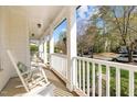Relaxing front porch with rocking chairs, offering a pleasant view of the neighborhood at 317 Flatrock Ln, Holly Springs, NC 27540