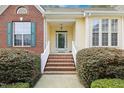 Inviting front porch with brick steps, white railings, and manicured bushes on either side at 3213 Kirby St, Durham, NC 27713