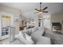 Spacious living room features a modern sectional couch, ceiling fan, and neutral decor at 3471 Forestdale Drive # 3C, Burlington, NC 27215