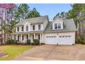 Charming two-story home with a two-car garage and well-manicured landscaping at 384 Rocky Run Ln, Lillington, NC 27546
