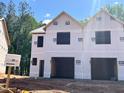 New construction townhome showing frame and garage, awaiting customization to create a modern living space at 39 Calluna Dr, Clayton, NC 27520